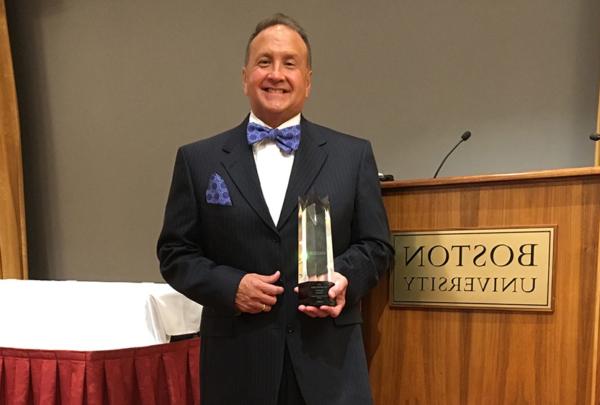 David Thaeler posing with award at Boston University